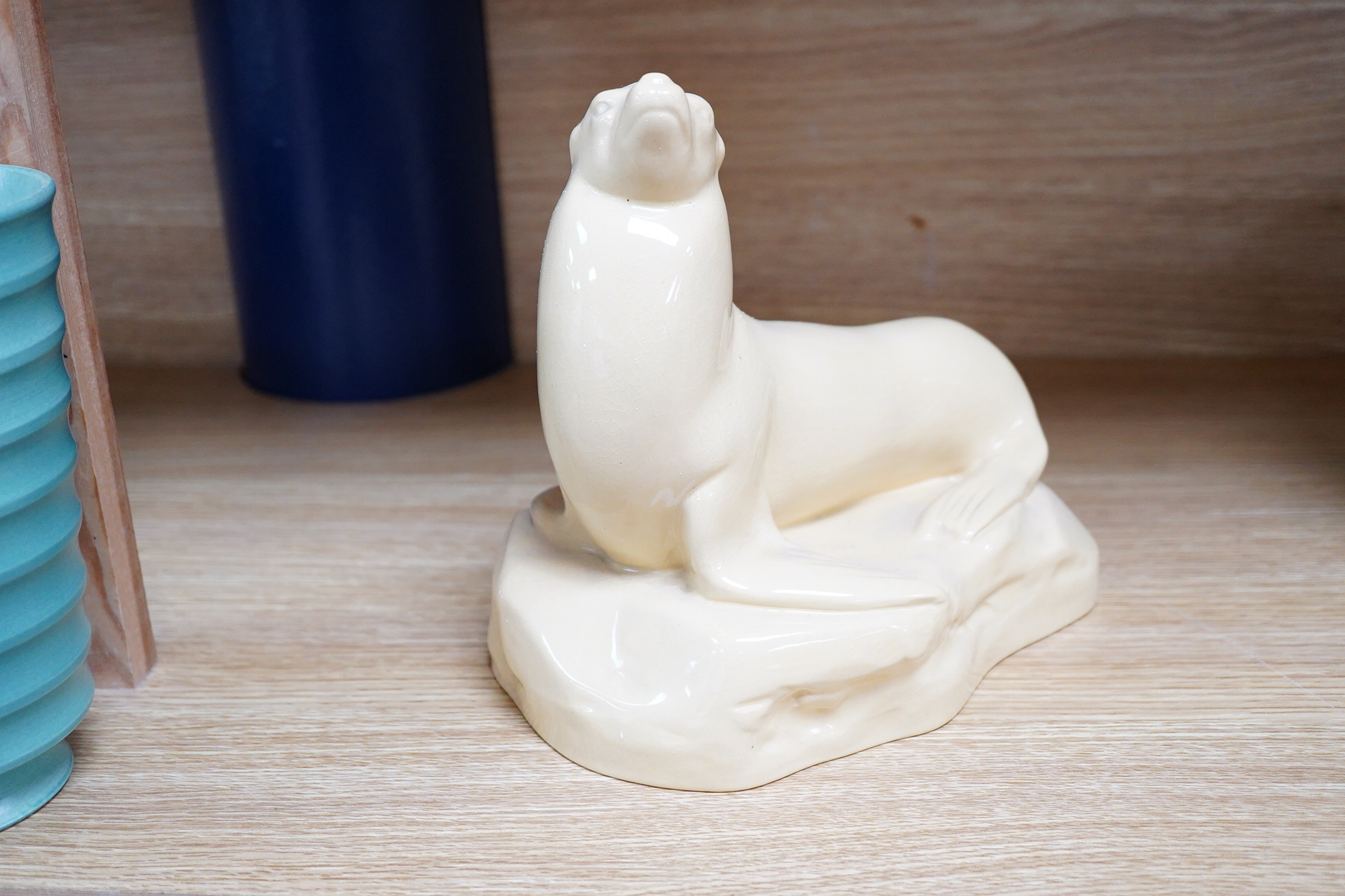 John Skeaping for Wedgwood, an Art Deco seal, straw glazed, 21cm wide
